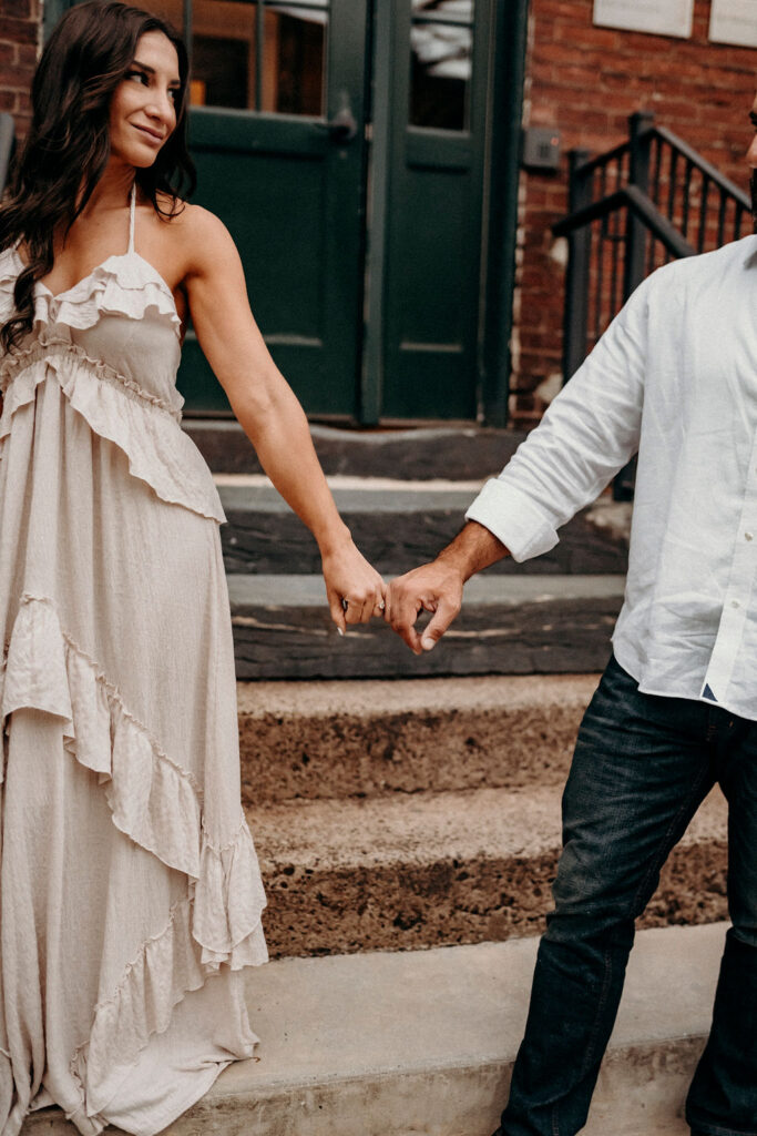 engagement photo- couple holding hands showing off ring
