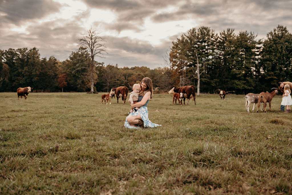 mom and son in middle of cow field during family photos