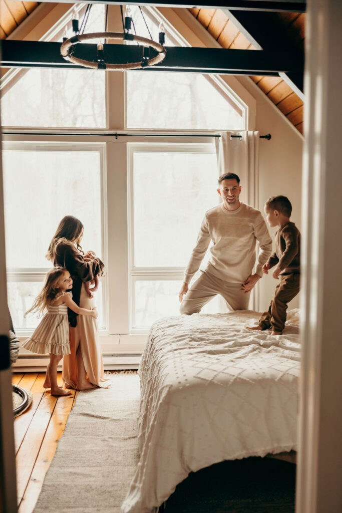 family photo during newborn photoshoot. kids playing in room