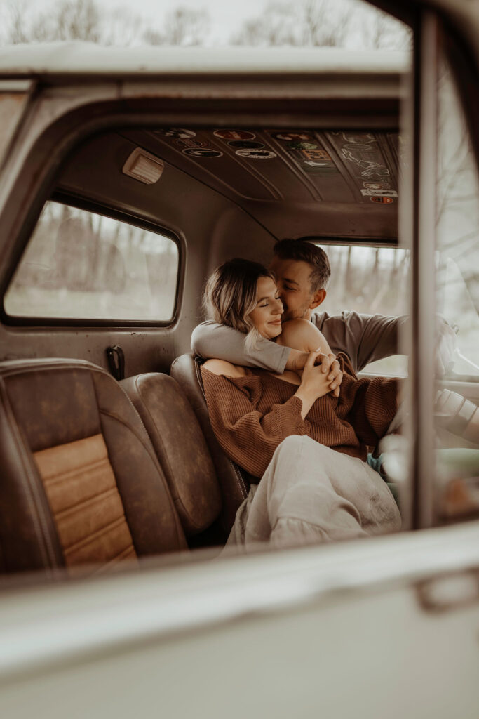couple sitting in old truck during couples photoshoot