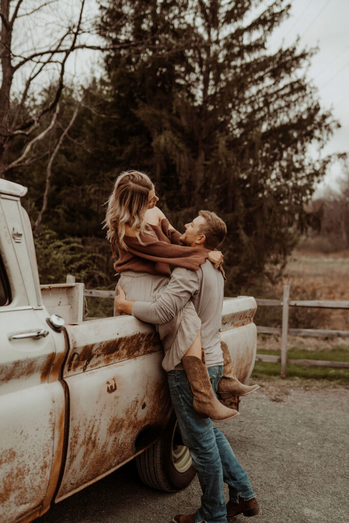 couple hanging out on old truck