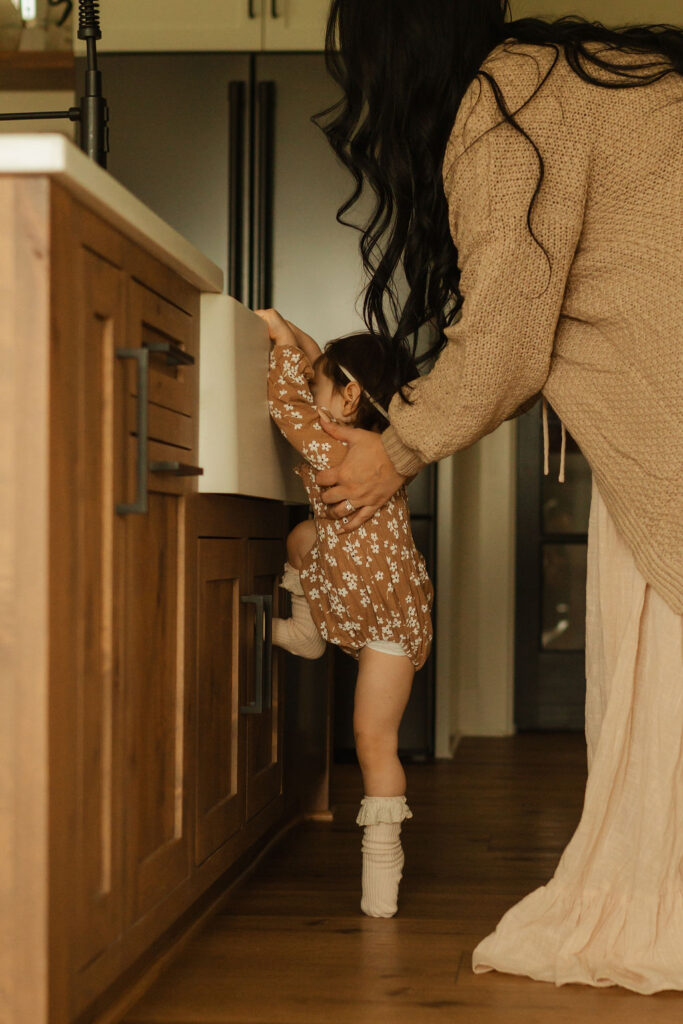 family helping daughter in sink