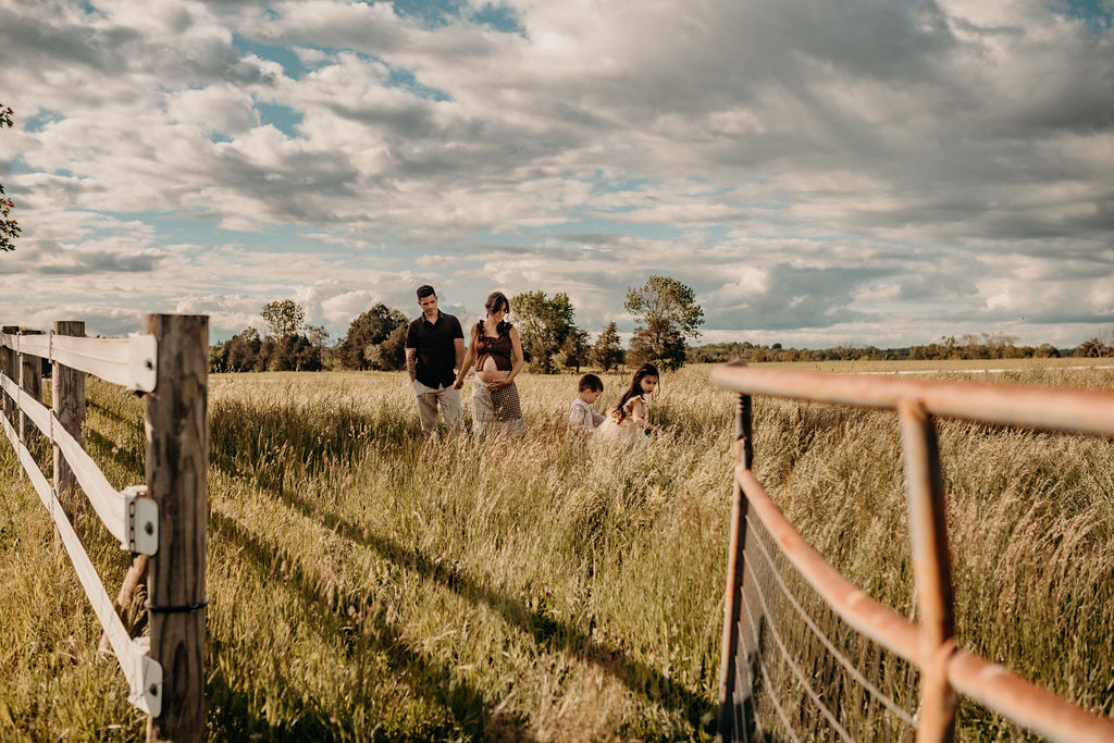 family photos at farm behind fence